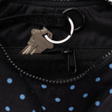Baggu Crescent Bag Small - Black and Sky Blue Micro Dot. Close up view of interior lining with internal zip and keychain holder. 