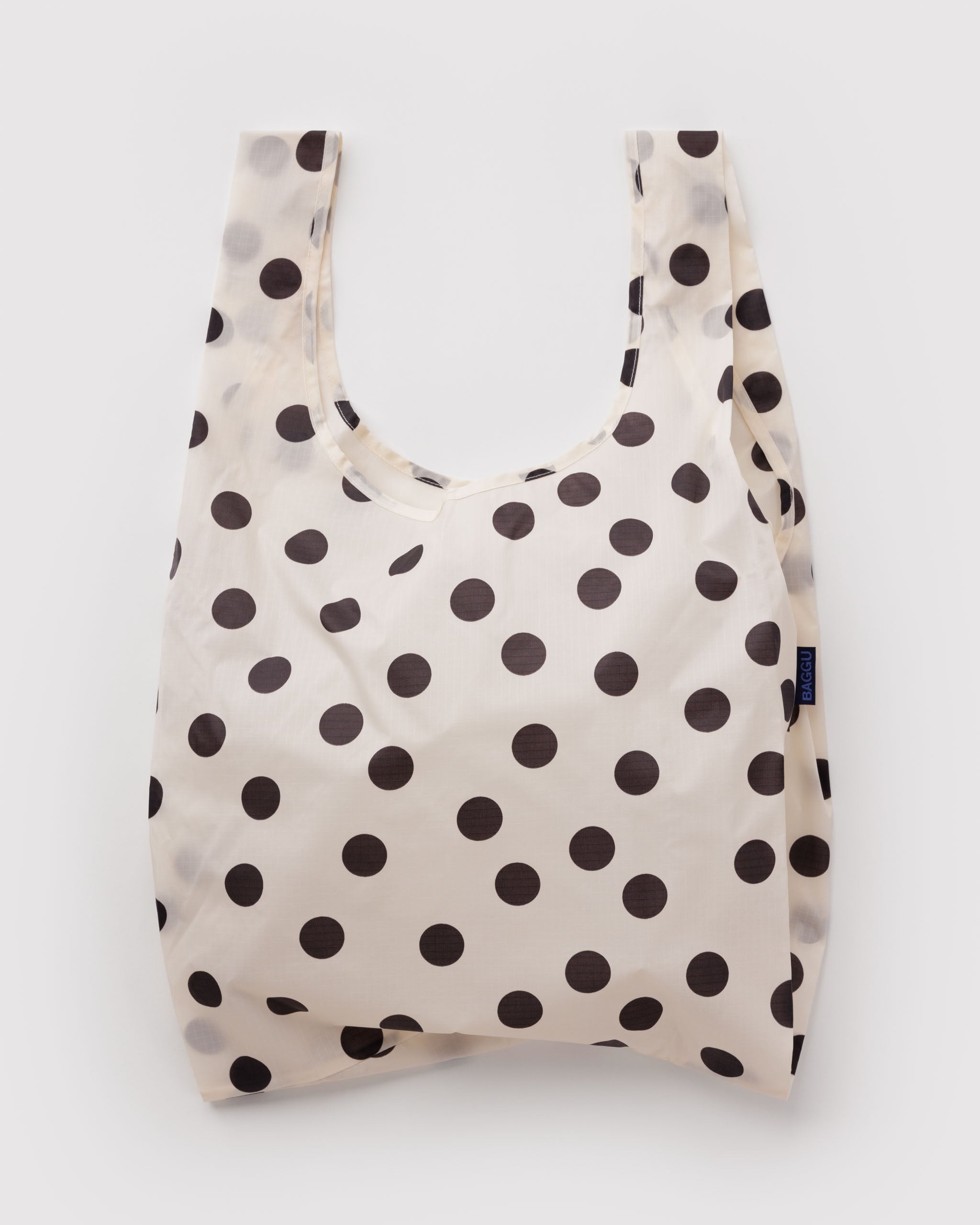 Standard Baggu Bag -  Black and Cream Polka Dot. Reusable shopping tote with cream background and black polka dot pattern.