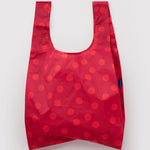 Standard Baggu Bag - Red Polka Dot. Reusable shopping tote with red background and lighter red polka dot pattern.