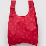 Standard Baggu Bag - Red Polka Dot. Reusable shopping tote with red background and lighter red polka dot pattern.